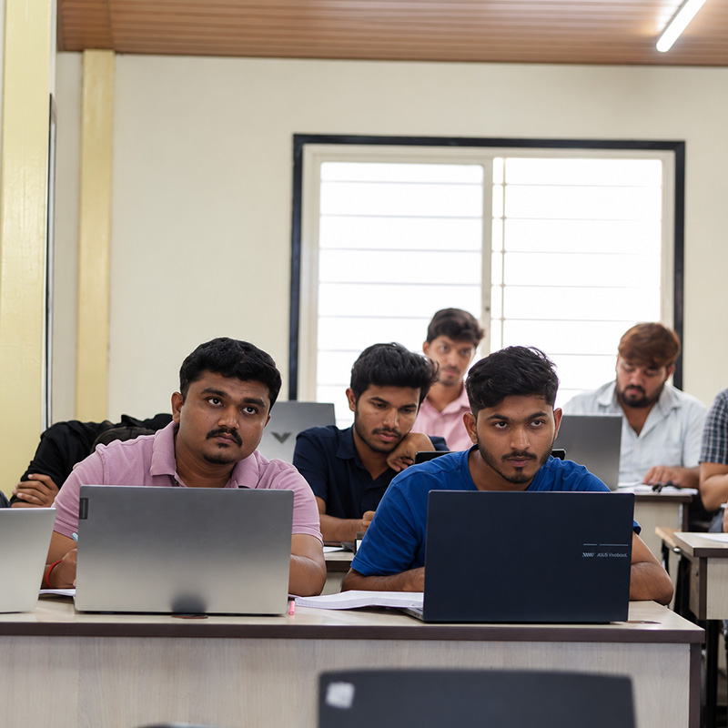 Students learning hands-on on laptops in a ScholarLogic class